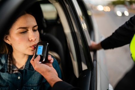 woman taking breathalyzer test